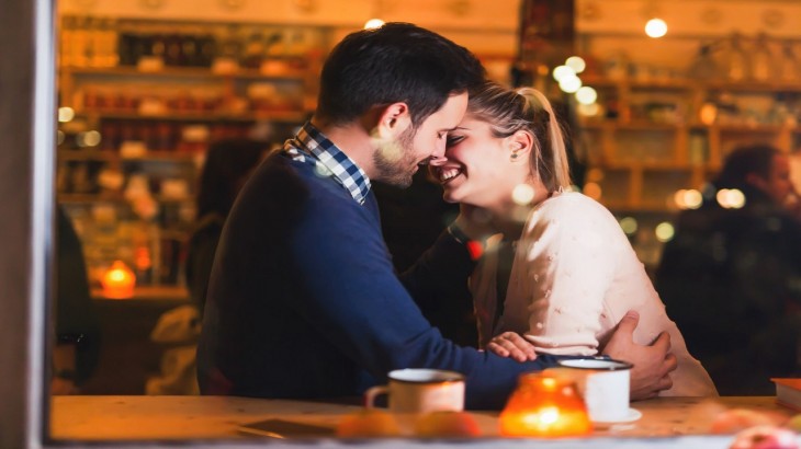 happy couple kissing at bar and having date royalty free image 1583341969
